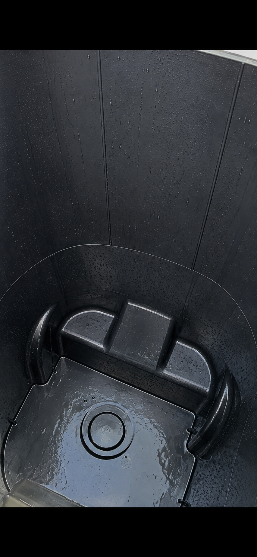 Clean black trash can — after